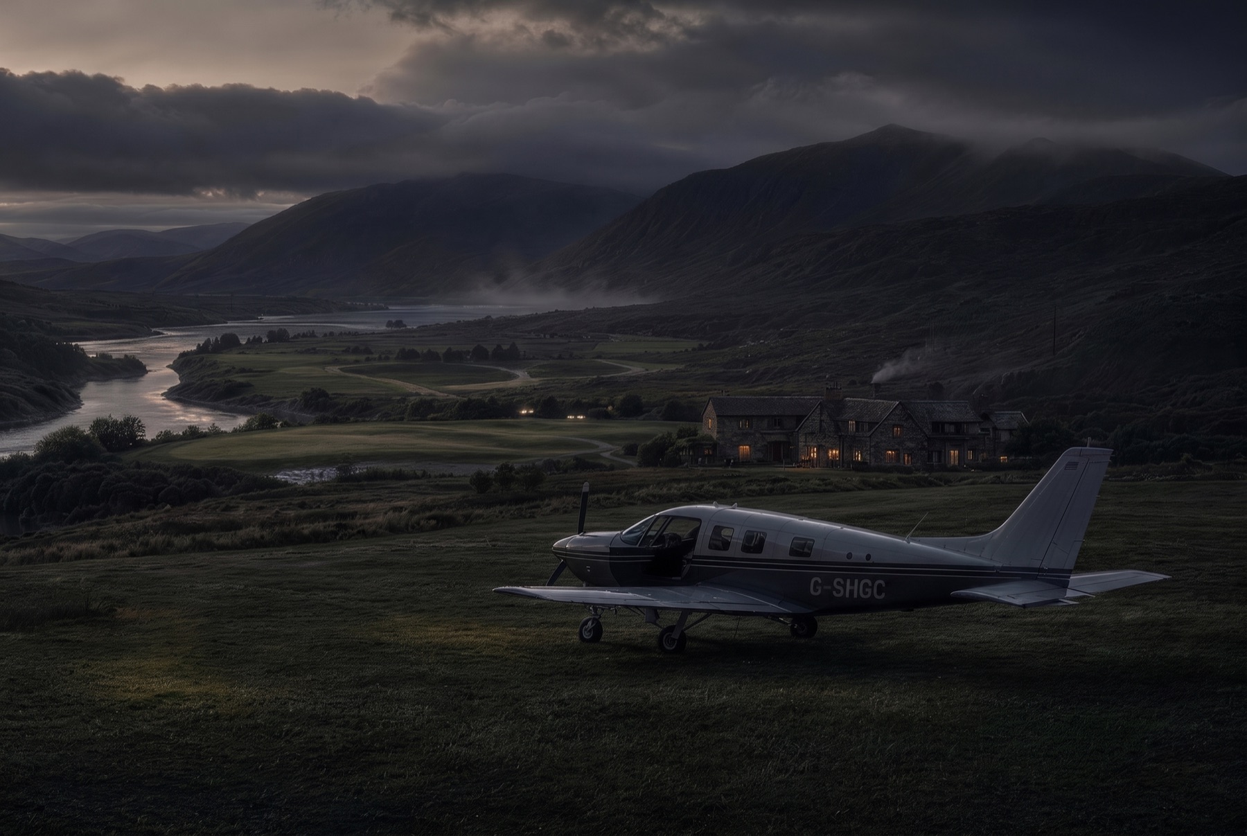A light aircraft parked on the grass strip at dusk, path lights lit, the lodge glowing beyond